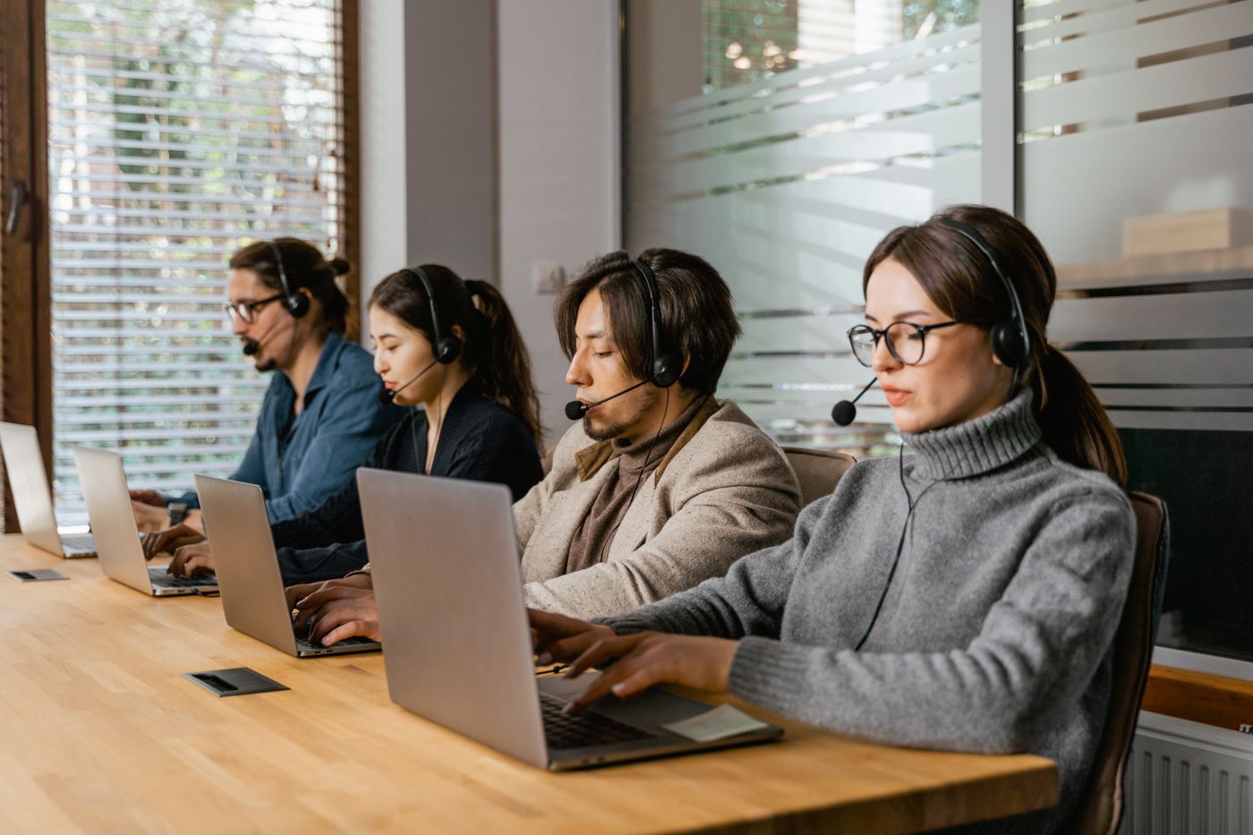 Support specialists assisting users from a shared workspace