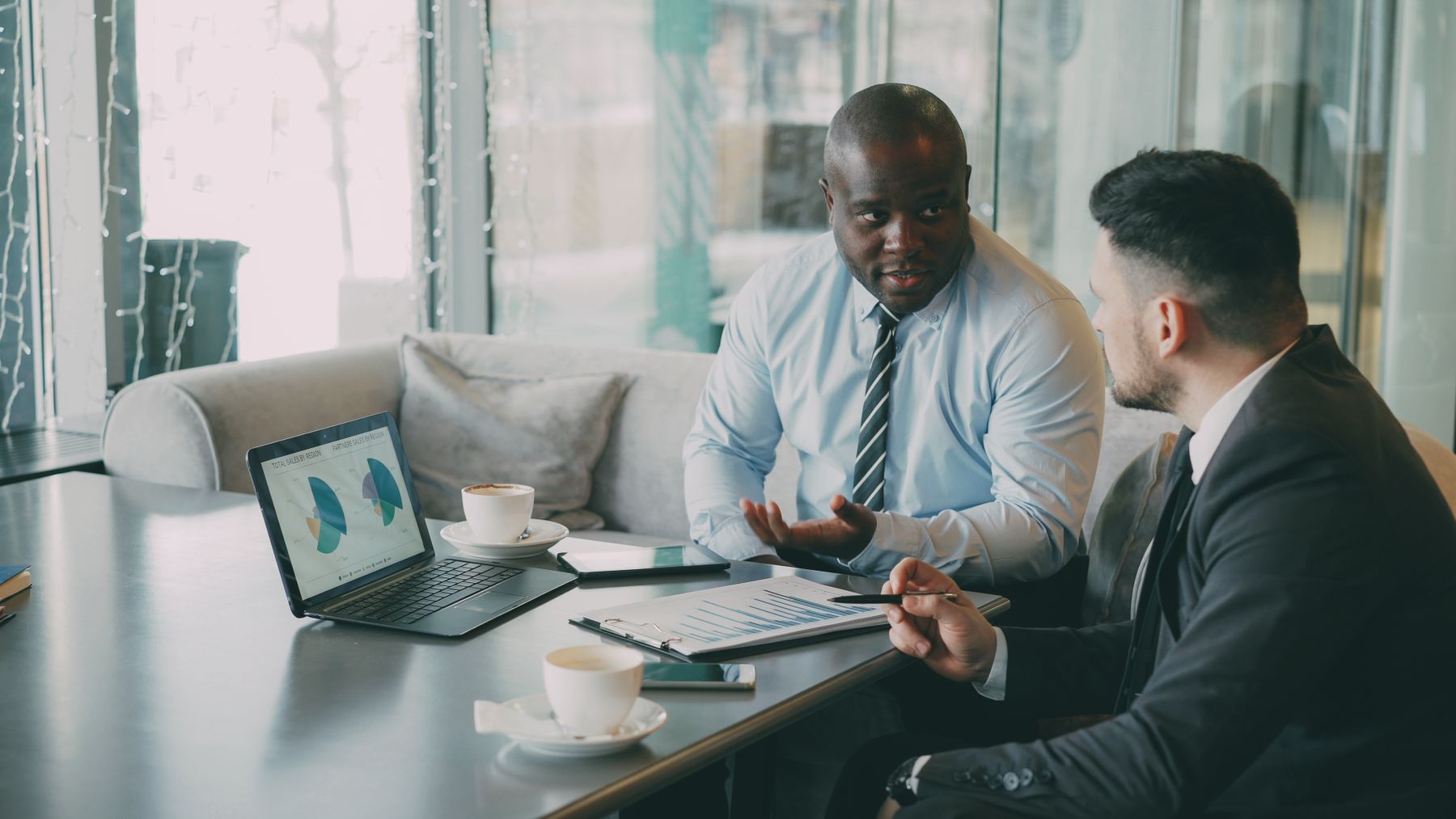 Two professionals discussing business requirements in a meeting